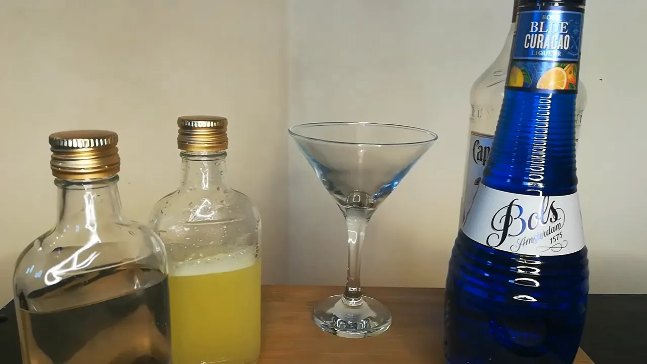Ingredients for Shark Bite drink including Malibu Rum, Blue Curacao, Pineapple Juice, Sprite, Grenadine, Lime Juice