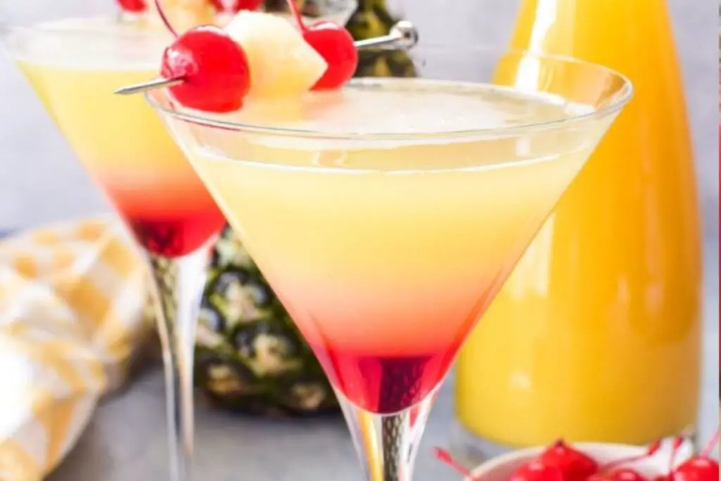 Pineapple Martini in a martini glass with pineapple wedge garnish