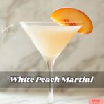 White Peach Martini in a glass with a peach slice garnish.